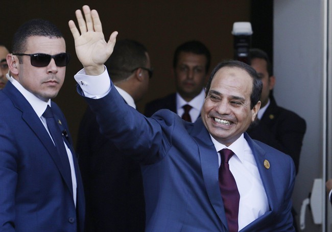 FILE - In this Aug. 6, 2015 file photo, Egyptian President Abdel-Fattah el-Sissi waves as he arrives to the opening ceremony of the new section of the Suez Canal in Ismailia, Egypt. 
