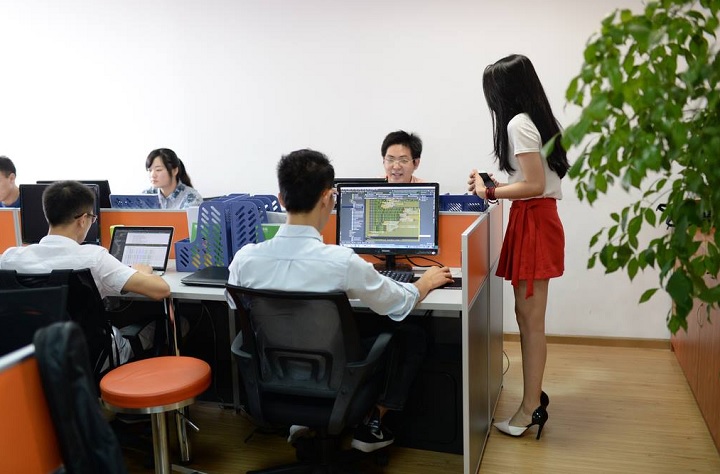 A cheerleader, standing, at an unnamed tech firm in China.