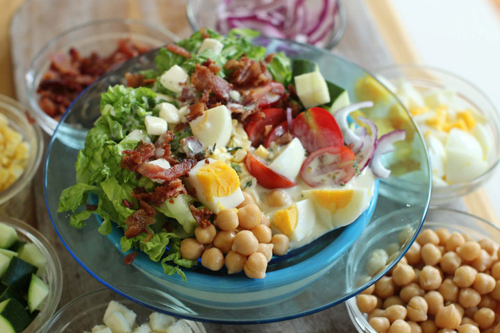 This July 13, 2015, photo, shows late summer cobb salad in Concord, N.H. This Cobb salad has chickpeas and eggs as the main proteins, and the traditional bacon as well, which could be left out for a vegetarian version.