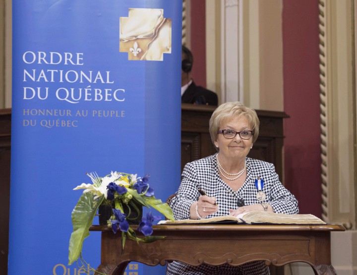 Colette Roy-Laroche, mayor of Lac-Mégantic, signs after she received the title of Chevalière de l'Ordre national du Québec during a ceremony, Tuesday, June 16, 2015 at the legislature in Quebec City.