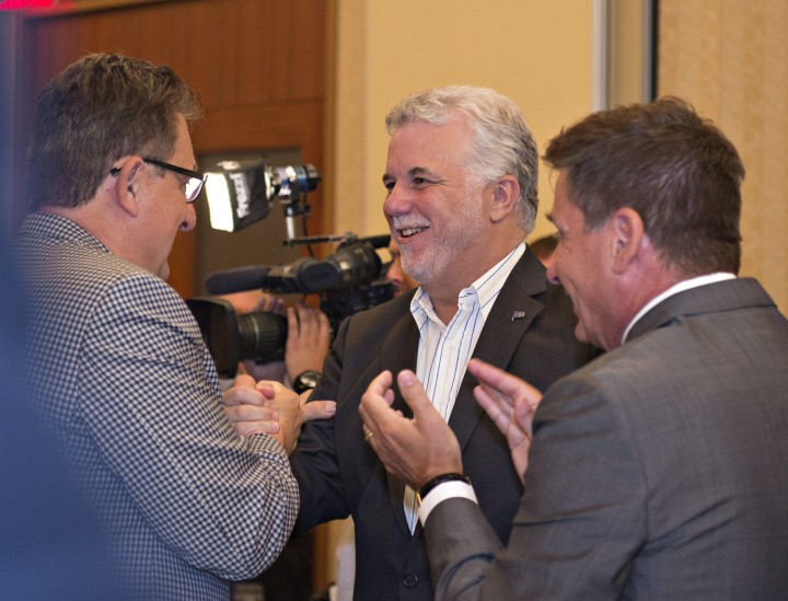 Quebec Premier Philippe Couillard is greeted by members at the beginning of a Quebec Liberal government caucus meeting, Thursday, August 27, 2015 in Saint-Georges-de-Beauce, Que.