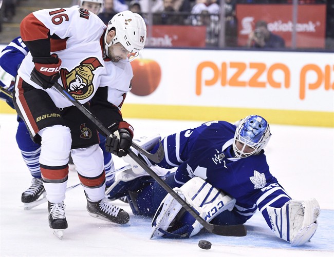 Toronto Maple Leafs' goalie Jonathan Bernier makes a save on a shot by Ottawa Senators' Clarke MacArthur during first period NHL action in Toronto on April 5, 2015.