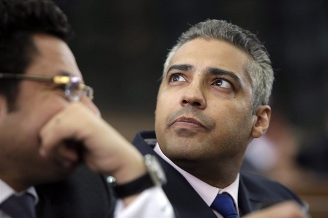 Canadian Al Jazeera English journalist Mohamed Fahmy, right, listens to his lawyer, Khaled Abou Bakr during his retrial in a courtroom, of Tora prison, in Cairo, Egypt, Monday, June 1, 2015. 