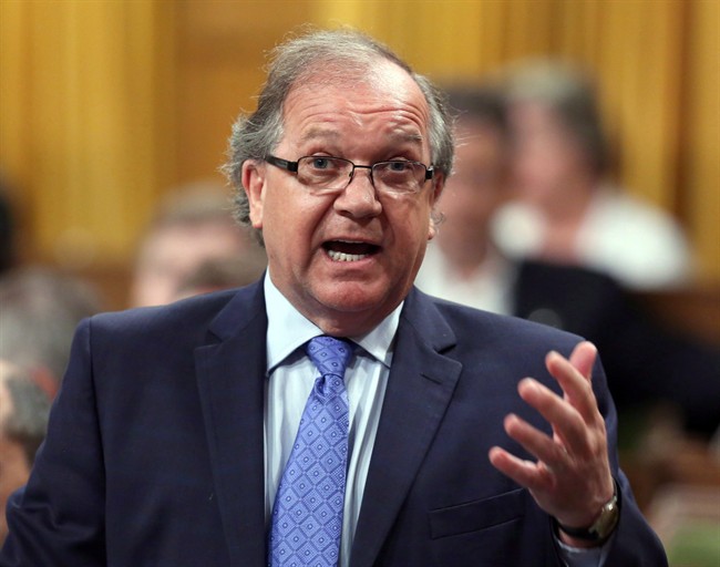 Aboriginal Affairs Minister Bernard Valcourt stands in the House of Commons during Question Period on Parliament Hill, Wednesday, June 10, 2015 in Ottawa. Lawyers for the federal government are expected in court Wednesday to persuade a judge to force five First Nations to open their books to the public.