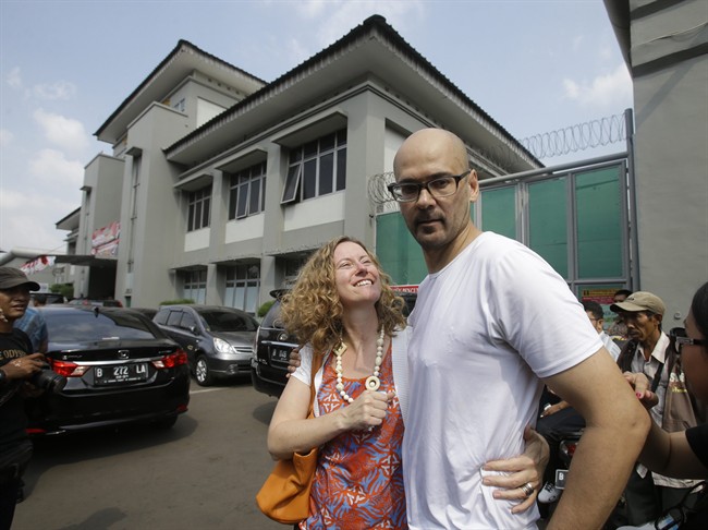Canadian teacher Neil Bantleman, right, hugs his wife Tracy, left, after he was released from Cipinang prison in Jakarta, Indonesia, Friday,Aug.14. 