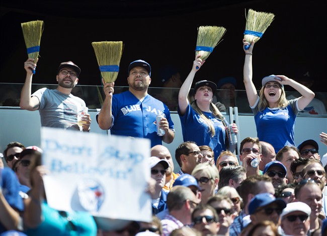Fans celebrate the Toronto Blue Jays' series sweep of the Oakland Athletics during MLB baseball action in Toronto on Thursday, August 13, 2015. THE CANADIAN PRESS/Darren Calabrese.