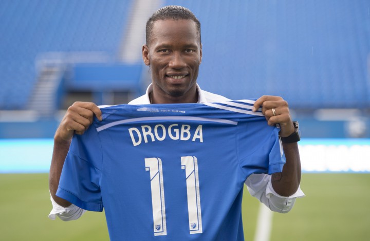 The Montreal Impact’s newest player Didier Drogba holds up his new team jersey following a news conference in Montreal, Thursday, July 30, 2015.