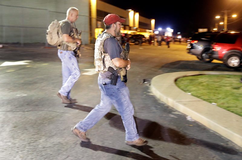 Heavily armed civilians with a group known as the Oath Keepers arrive in Ferguson, Mo., early Tuesday, Aug. 11, 2015.
