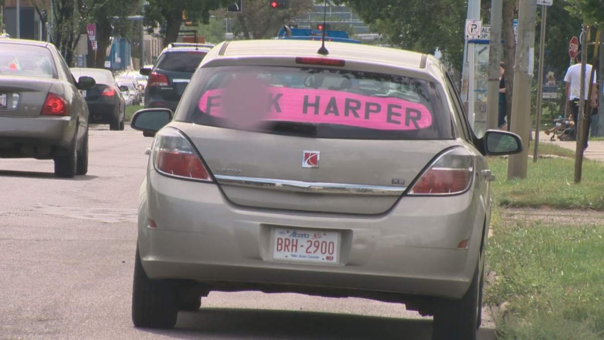A car with ‘F– Harper’ sign in the back window was parked on 109 Street in Edmonton on Thursday, August 20, 2015.