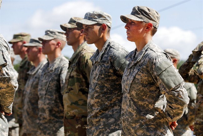 U.S. Army First Lt. Shaye Haver, right, stands in formation during an Army Ranger school graduation ceremony Friday, Aug. 21, 2015, at Fort Benning, Ga. Haver and Capt. Kristen Griest became the first female soldiers to complete the Army's rigorous school, putting a spotlight on the debate over women in combat.