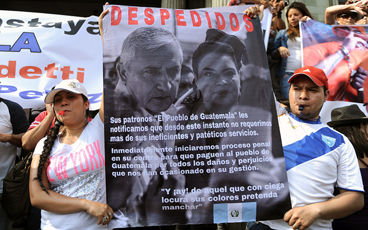Demonstrators hold a sign "dismissing" Guatemalan President Otto Perez Molina and Vice President Roxana Baldetti during a protest against the recent corruption cases in the government, in Guatemala City on April 25, 2015. 
