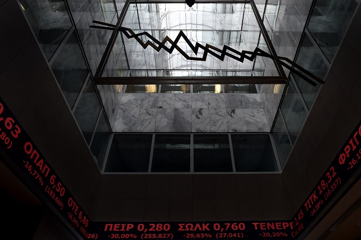 Stock index boards are pictured in the lobby of the Athens Stock Exchange in Athens on August 3, 2015. 