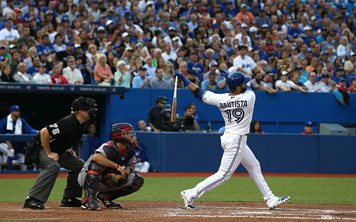 Jose Bautista, watches as his ball clears the wall for a grand slam  as the Toronto Blue Jays beat the Minnesota Twins at the Rogers Centre in Toronto on August 5, 2015.