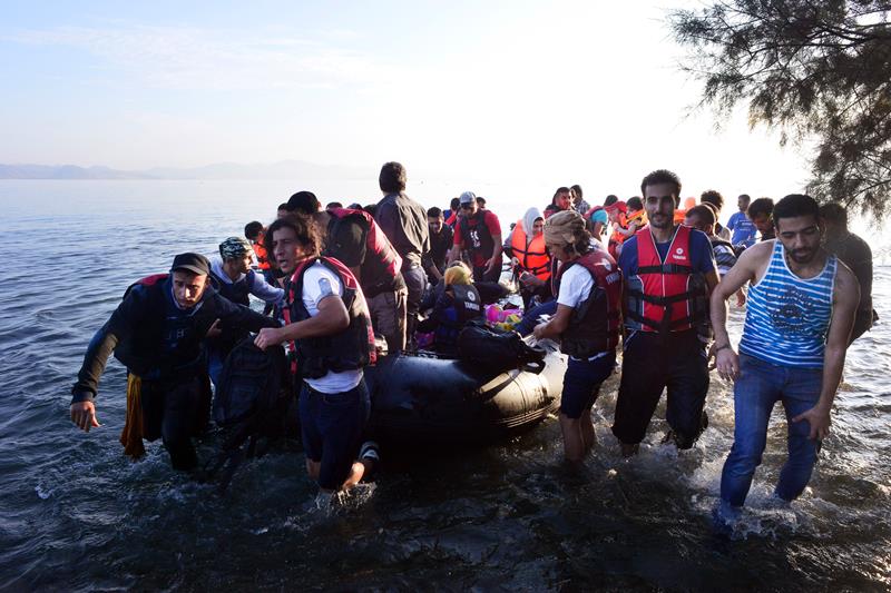 Syrian refugees arrive at a beach on the Greek island of Kos after crossing a part of the Aegean sea from Turkey to Greece in a dinghy on August 15, 2015 in Kos, Greece.