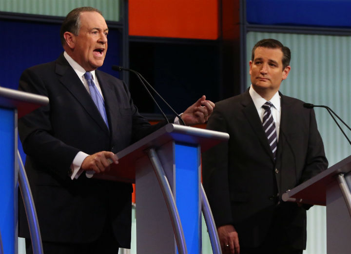 Republican presidential candidate Mike Huckabee speaks as Ted Cruz listens during the first Republican presidential debate at the Quicken Loans Arena Thursday, Aug. 6, 2015, in Cleveland.