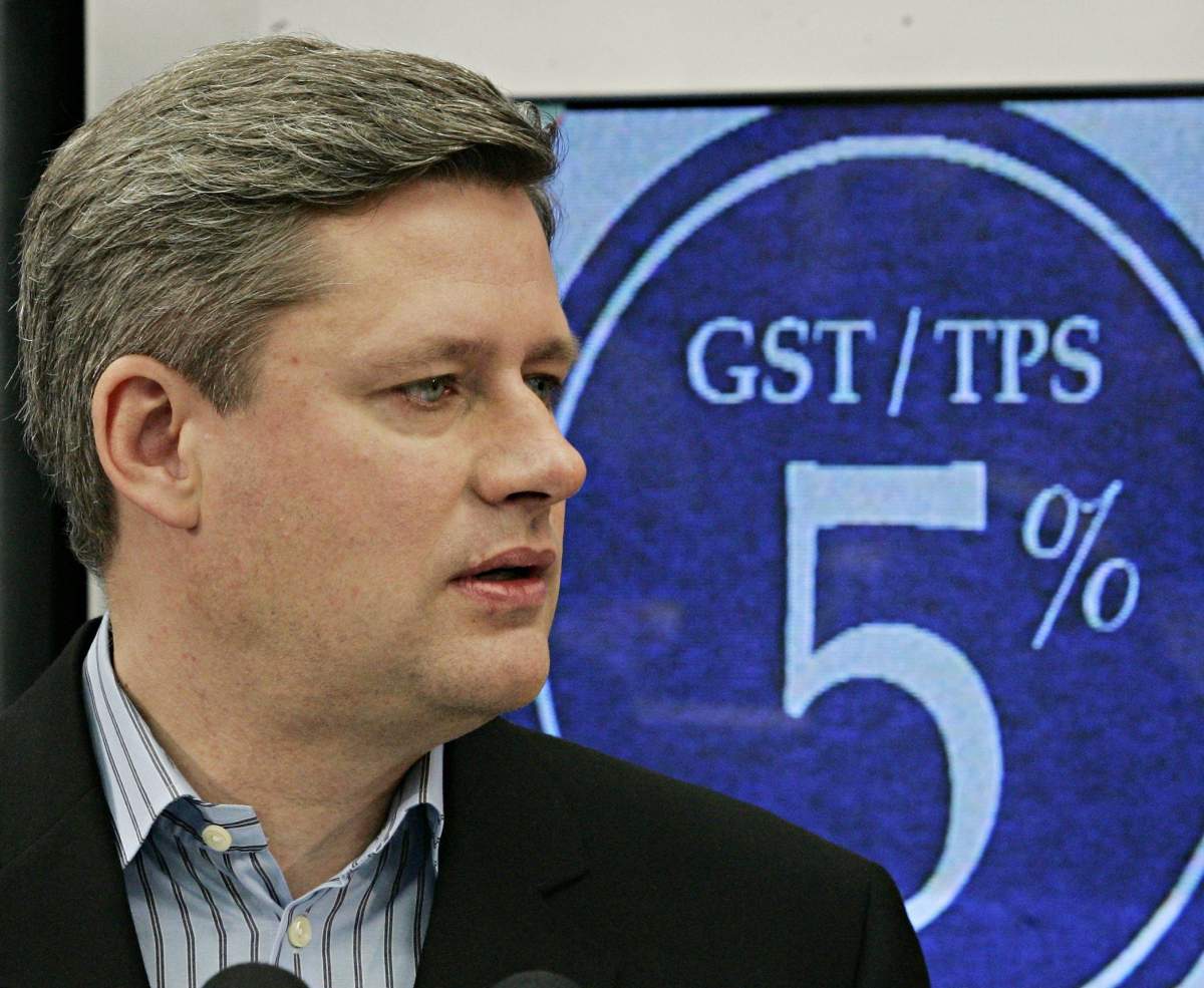 FILE-- Stephen Harper stands in front of a television displaying a 5% GST at an electronics store in Mississauga, Ont., in this December 1, 2005 file photo. 