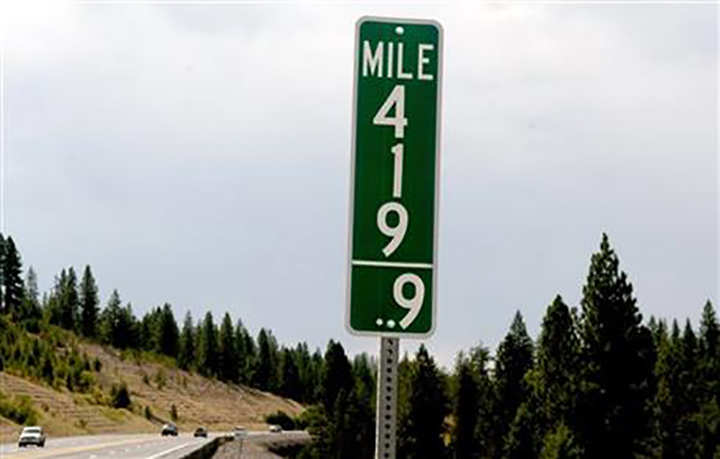 In this Tuesday, Aug. 11, 2015 photo, vehicles pass a 419.9 milepost just south of Coeur d'Alene, Idaho.
