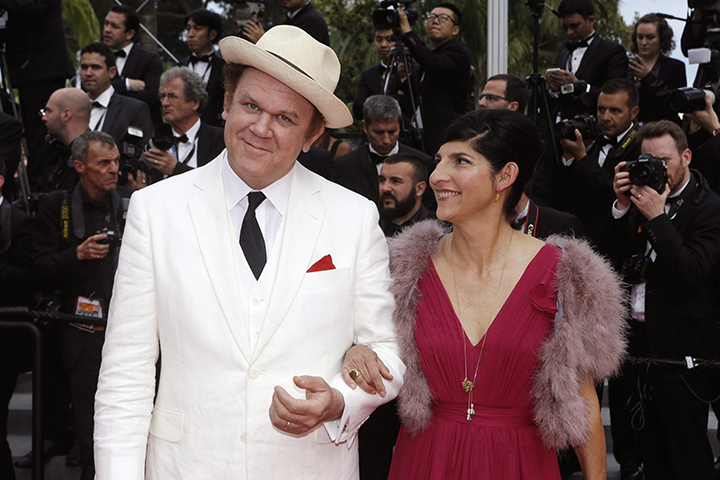 Actor John C. Reilly, left, and his partner Alison Dickey pose for photographers upon arrival for the awards ceremony at the 68th international film festival, Cannes, southern France, Sunday, May 24, 2015.