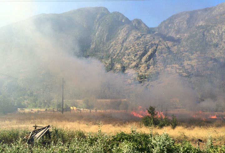 This fire burning west of Keremeos on Saturday closed Highway 3 for hours.