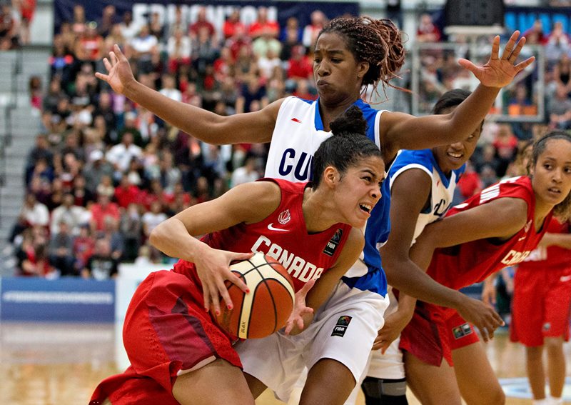Canada's Kia Nurse, bottom, drives past Cuba's Francy Ochoa Izquierdo, top, during first half action at the 2015 FIBA Americas Women's Championship Final in Edmonton, Alta., on Sunday, August 16, 2015. 