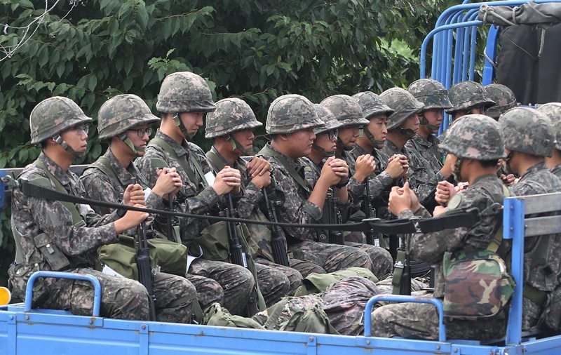 South Korean army soldiers ride on a truck in Yeoncheon, south of the demilitarized zone that divides the two Koreas, in South Korea, Saturday, Aug. 22, 2015. South Korea and North Korea agreed Saturday to hold their first high-level talks in nearly a year at a border village to defuse mounting tensions that have pushed the rivals to the brink of a possible military confrontation.