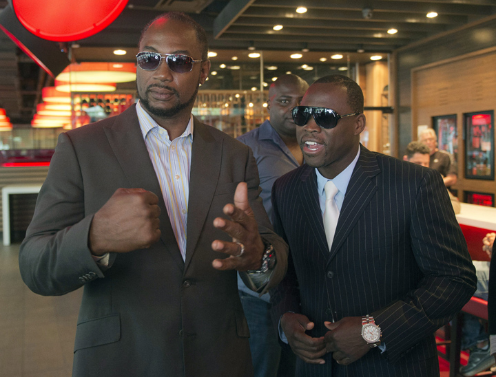 WBC light heavyweight champion Adonis Stevenson, from Montreal, right, chats with former world heavyweight champion and now promoter Lennox Lewis before a press conference Thursday, August 6, 2015 in Montreal.