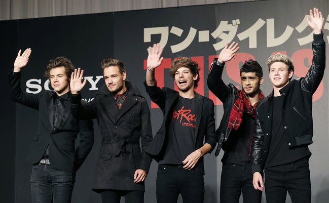 In this March 25, 2015 file photo, members of One Direction wave during an event to promote their film "One Direction: This Is US," in Makuhari, near Tokyo.