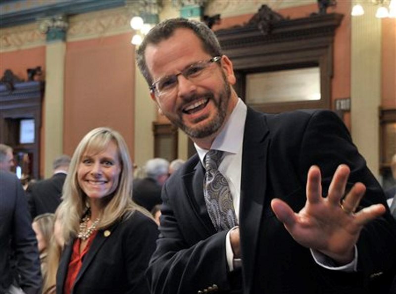 In this Jan. 14, 2015 photo, Rep. Cindy Gamrat, R-Plainwell, and Rep Todd Courser, R-Lapeer wave to reporters in the House of Representatives in Lansing. 