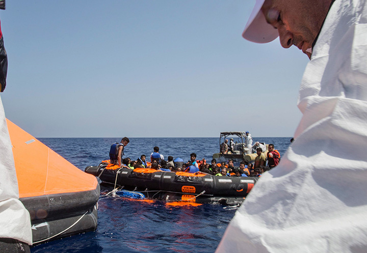 Migrants are brought aboard Irish and Italian Navy life-boats to the Dignity I MSF search and rescue vessel which responded to the capsizing of a crowded fishing boat in the Mediterranean Sea, off the coast of Libya, Wednesday, Aug. 5, 2015. 
