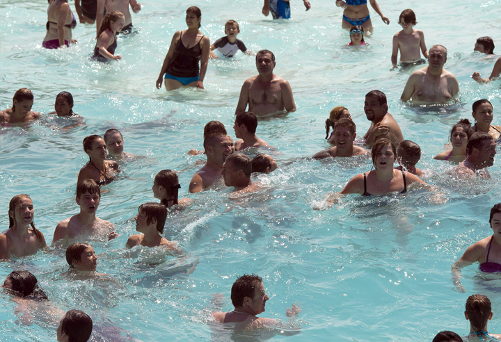 Bathers bob in the wave pool to beat the 30 C heat at the Super Aqua club, Tuesday, July 28, 2015 in Pointe-Calumet, Que.
