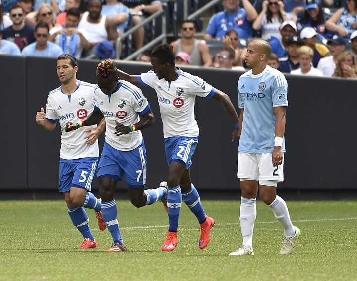 Montreal Impact defender Ambroise Oyongo (2) congratulates forward Dominic Oduro (7) on his goal running with midfielder Dilly Duka (5) as New York City FC defender Andres Mendoza (2) reacts in the first half of an MLS soccer game at Yankee Stadium on Saturday, August 1, 2015, in New York. (AP Photo/Kathy Kmonicek).