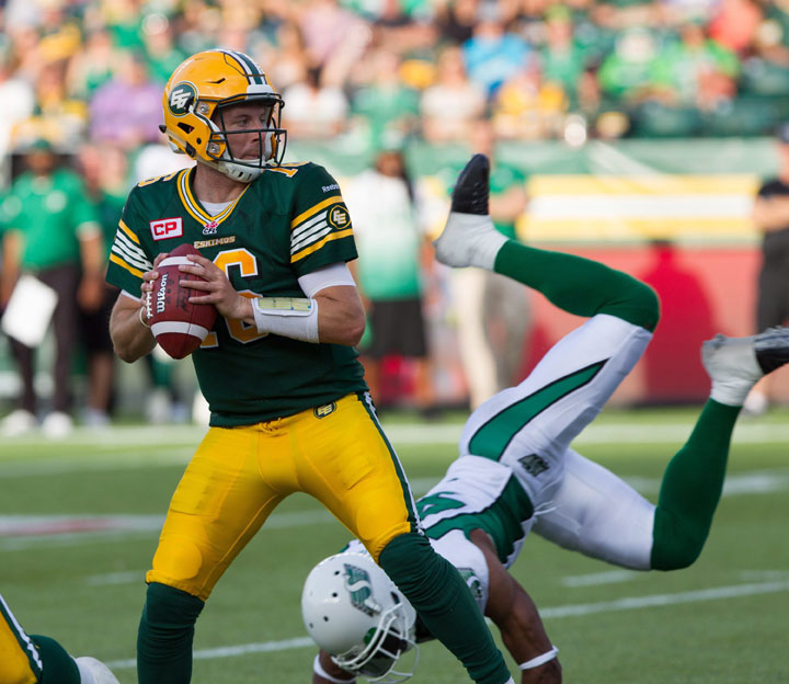 Edmonton Eskimos ' Matt Nichols (16) searches for an opening while playing against the Saskatchewan Roughriders during CFL first half action in Edmonton, Alta., on Friday July 31, 2015.