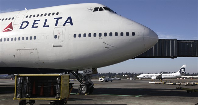 Delta Air Lines 747-400 airplane sits parked at Seattle-Tacoma International Airport in Seattle. Delta Airlines on Monday, Aug. 3, 2015 said that it would no longer accept lion, leopard, elephant, rhinoceros and buffalo hunting trophies. AP Photo/Ted S. Warren/File.
