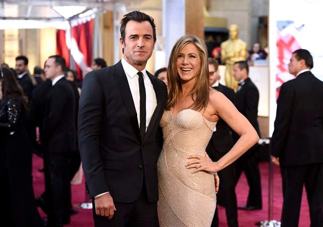 FILE - In this Feb. 22, 2015 file photo, Justin Theroux, left, and Jennifer Aniston arrive at the Oscars in Los Angeles. Howard Stern has revealed details about the secret wedding between Jennifer Aniston and Justin Theroux, including that Jimmy Kimmel officiated. 