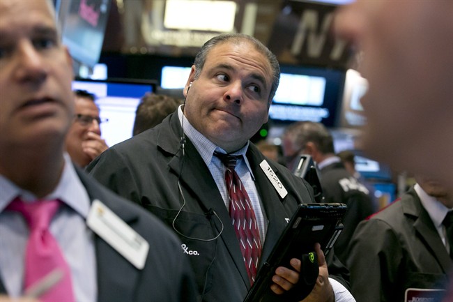 Trader Anthony Riccio works on the floor of the New York Stock Exchange Tuesday, Aug. 11, 2015. U.S. stocks opened lower on Tuesday, led by declines in energy and materials stocks as commodities prices dropped. Prices for oil and copper fell sharply after China's government lowered the value of its currency, suggesting weakness in the world's second-largest economy. (AP Photo/Richard Drew)