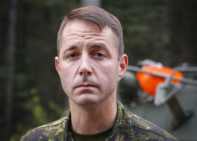 Lt.-Col. Mason Stalker is interviewed as Canadian troops fight fires in Montreal Lake, Sask., on July 9, 2015. A court appearance has been put over for a high-ranking military officer on sex charges. A lawyer appeared on behalf of Lt.-Col. Mason Stalker in Edmonton provincial court Thursday on 10 charges, including sexual assault.