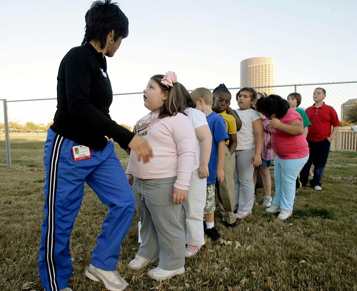 Children line up to play in a game of kickball during a program in Dallas to help families with overweight children get healthier in this March 2007 file photo.