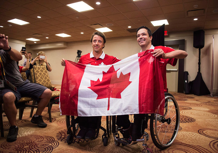 Athlete Ambassador for the Parapan America Games Josh Dueck, left, presents boccia player Marco Dispaltro as the flag bearer for Team Canada during a press conference in Toronto on Wednesday, August 5, 2015.