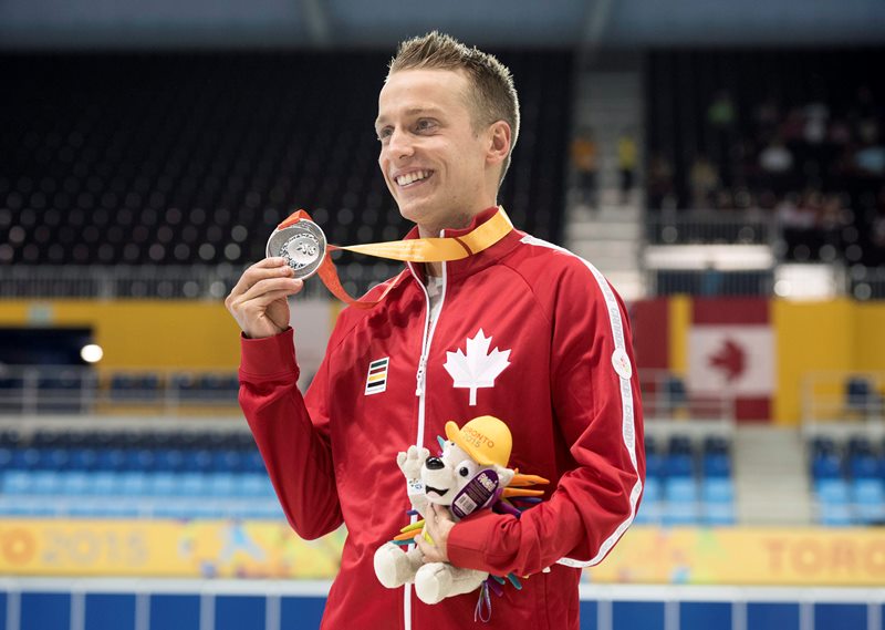 Jean-Michel Lavalliere, of Canada, poses with his silver medal in the men's 200m IM SM7 final at the Parapan Am Games in Toronto on Tuesday, August 11, 2015. 