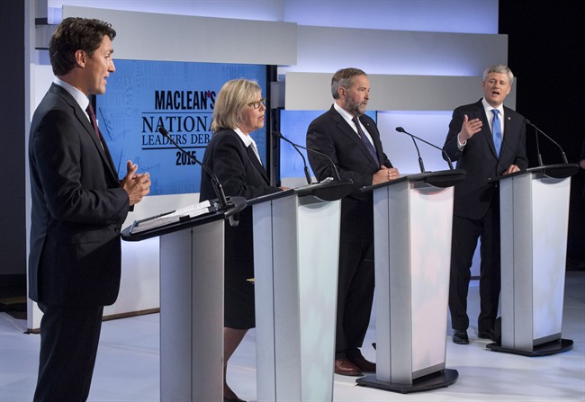 Liberal leader Justin Trudeau, Green Party leader Elizabeth May and New Democratic Party leader Thomas Mulcair listen as Conservative Leader Stephen Harper take part in the first leaders debate Thursday, August 6, 2015 in Toronto. 