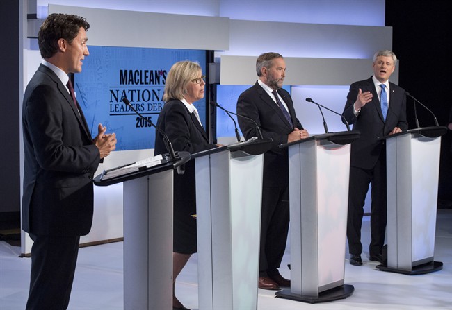 Liberal leader Justin Trudeau, Green Party leader Elizabeth May and New Democratic Party leader Thomas Mulcair listen as Conservative Leader Stephen Harper take part in the first leaders debate Thursday, August 6, 2015 in Toronto.