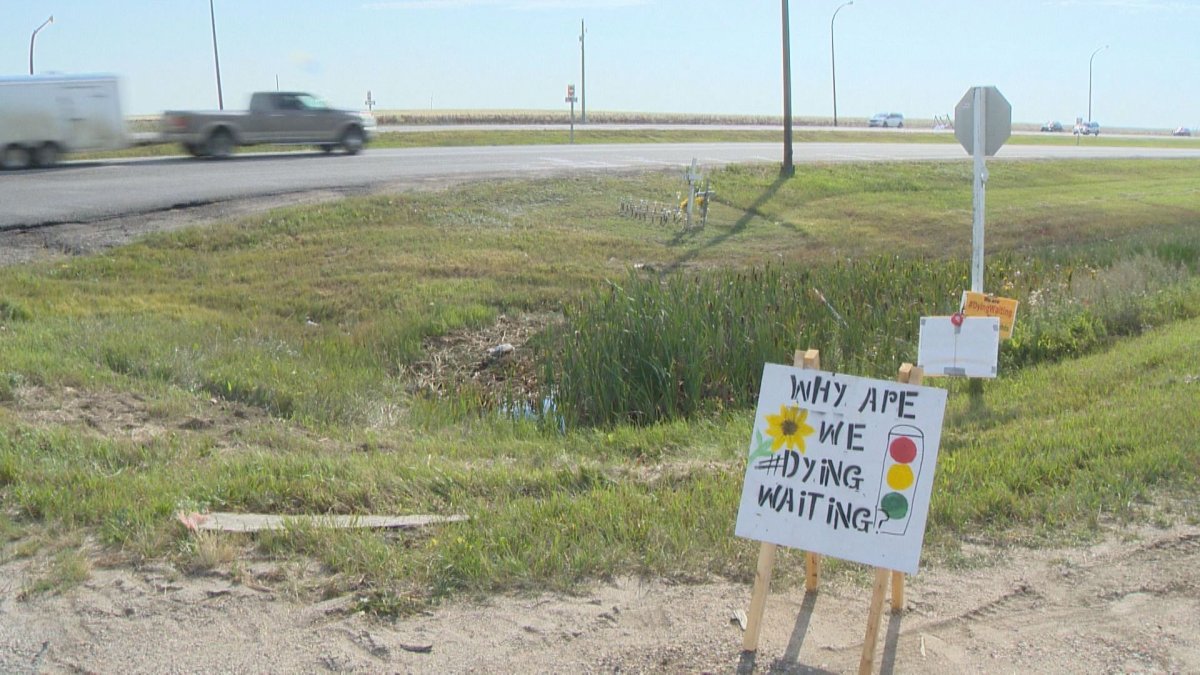 A sign for the #DyingWaiting campaign sits near Highway 1 during a vigil.