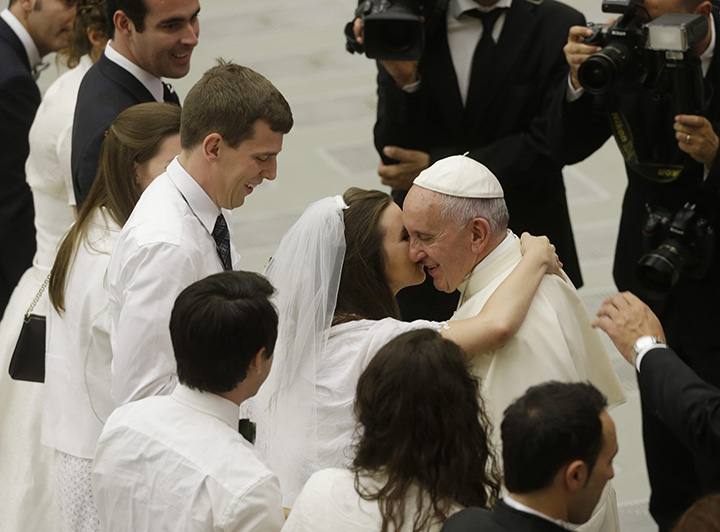Pope Francis greets newlyweds during the general audience in the Paul VI hall at the Vatican, Wednesday, Aug. 5, 2015. 