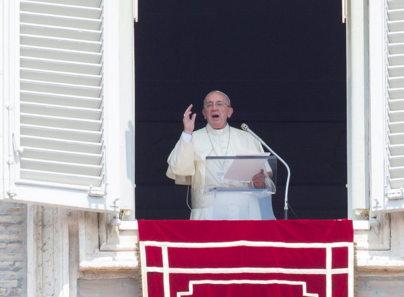 Pope Francis recites the Angelus noon prayer from his studio window overlooking St. Peter's Square at the Vatican, Sunday, Aug. 9, 2015. Pope Francis said the detonation of atomic bombs at Hiroshima and Nagasaki 70 years ago remains "a permanent warning to humanity" to reject war and ban weapons of mass destruction. 