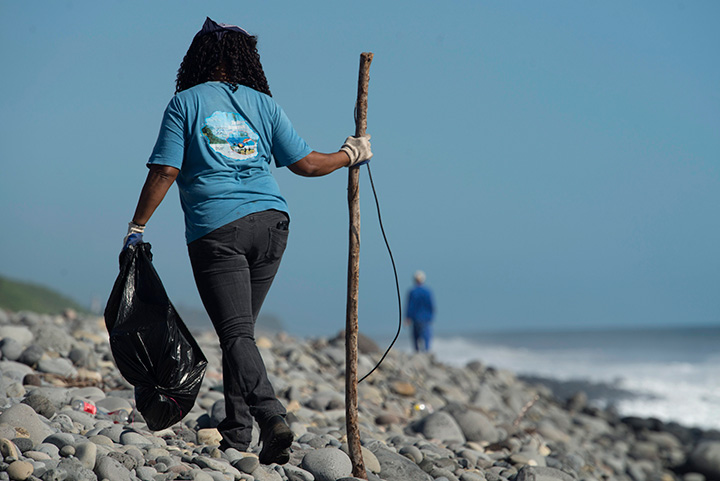 A municipal worker searches Reunion Island beach where expected debris of the missing Malaysia Airlines Flight 370 could be washed up onto the shore near Saint-Andre. 