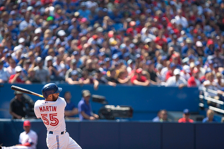Toronto Blue Jays Russell Martin watches the flight of the ball as he hits a two-run homer off Detroit Tigers pitcher Alfredo Simon during fourth inning Major League baseball action in Toronto on Sunday, August 30, 2015. 
