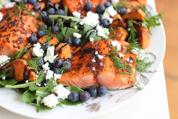 This photo shows broiled sockeye salmon with blueberries and sweet potatoes.