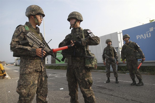 South Korean army soldiers stand guard on Unification Bridge, which leads to the demilitarized zone, near the border village of Panmunjom in Paju, South Korea, Monday, Aug. 24, 2015. 