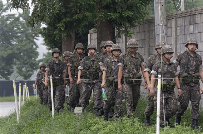 South Korean army soldiers walk on the way to returning to their base after a patrol, in Paju, south of the demilitarized zone that divides the two Koreas, South Korea, Friday, Aug. 21, 2015. 
