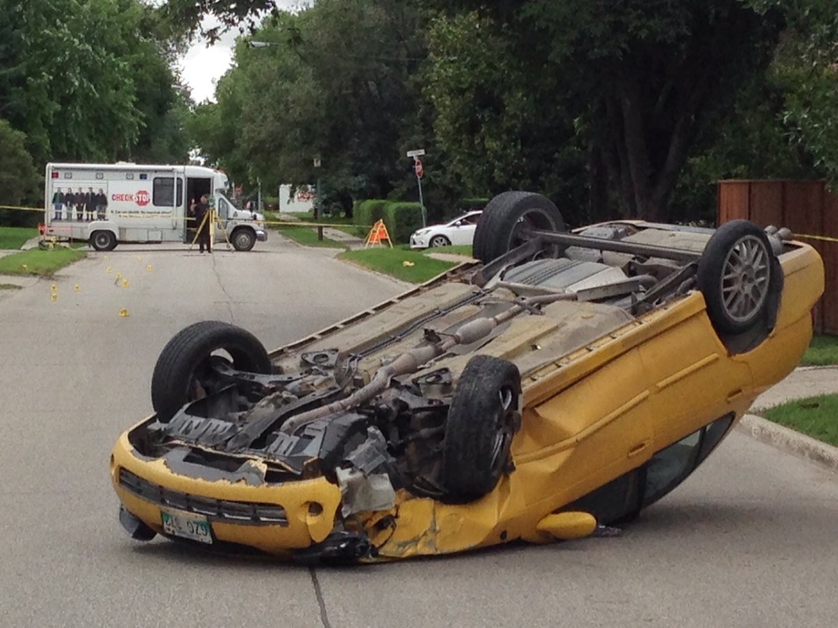 Police block off a section of roadway to investigate after a car flipped on its roof Sunday.